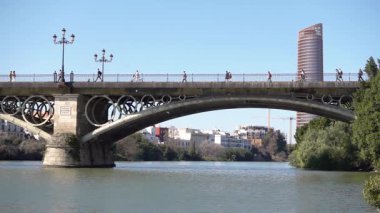 Sevilla şehrindeki köprü İspanya yavaş çekimde yürüyen insanlar