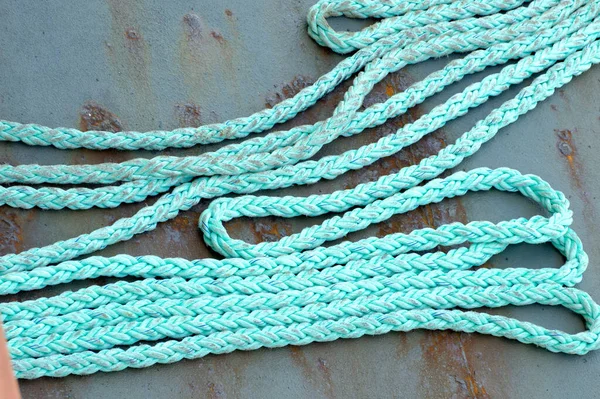 Old, frayed Blue Rope on the deck of a ship