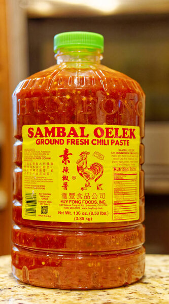 CUMMING, GEORGIA - December 26, 2023: Sambal is an Indonesian chili sauce or paste, made from a mixture of chilli peppers with garlic, ginger, shallot, scallion, palm sugar, and lime juice.