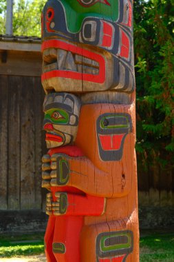 VICTORIA, BC, CANADA - July 11, 2023:: Totem poles are monuments created by First Nations of the Pacific Northwest to represent and commemorate ancestry, histories, people, or events. clipart