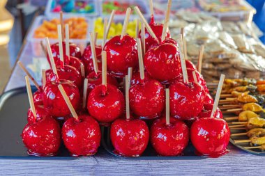 Red Candy Apples on Stick for Sale at Winter Carnival