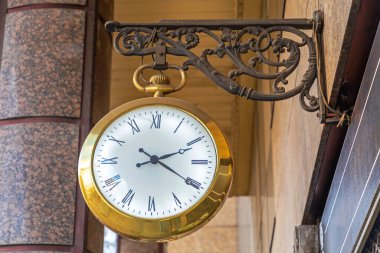 Golden Pocket Clock With Illuminated White Dial Hanging