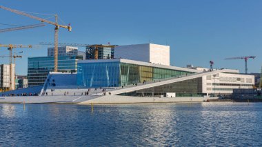 Oslo, Norway - October 29, 2016: People Walking at Modern Opera Building in Capital City at Sunny Autumn Day.