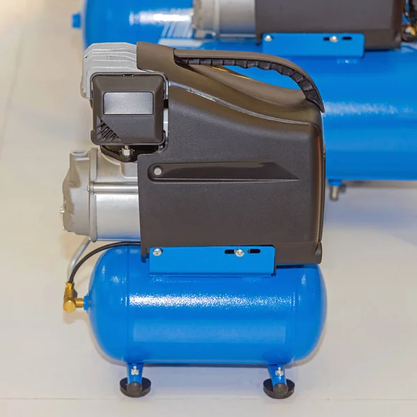 Small Blue Portable Air Compressor Device Workshop — стокове фото
