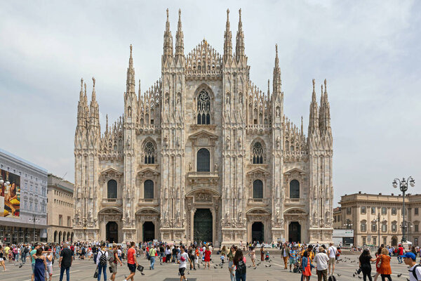 Milan, Italy - June 15, 2019: Crowd of People in Front of Duomo di Milano Massive Gothic Cathedral in Milan, Italy.
