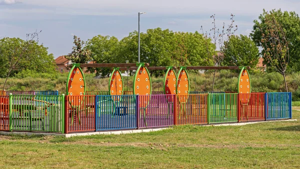 Multi Colour Fence Around Children Playground in Park