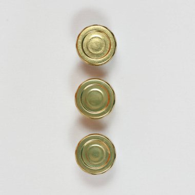 Three Small Jars With Golden Lids Top View clipart