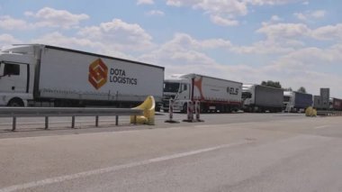 Horgos Roszke, Hungary - August 01, 2022: Long Queue of Trucks Shipping Cargo Stuck at EU Border Logistics Problems.