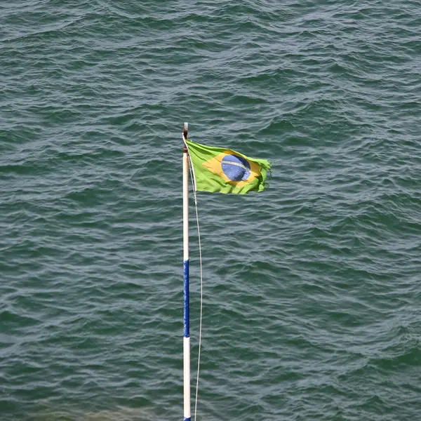 Brasil Flag at Pole Sea Water Sunny Summer Day