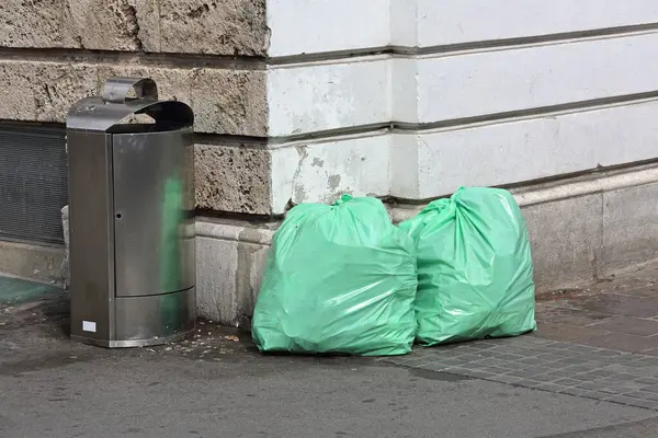 Two Garbage Bags and Trash Bin at Street Corner Ljubljana Slovenia