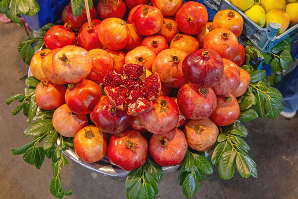 Big Bunch of Fresh Pomegranates Fruits at Farmers Market