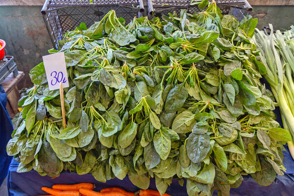 Large Pile of Spinach Leafy Greens Vegetable at Farmers Market