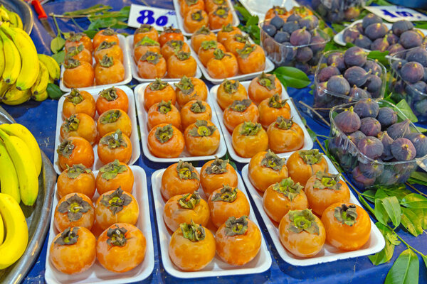 Oriental Persimmon Kaki Fuyu Apple Fruits at Trays