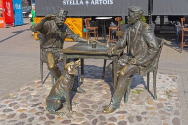 Nis, Serbia - August 04, 2022: Bronze Sculpture of Kalca and Stevan Sremac Monument Landmark at Kopitareva Street in City Centre. clipart