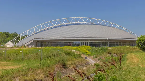 stock image Indjija, Serbia - July 03, 2023: Steel Arch Metal Dome Structure Sports Hall Complex at Sunny Summer Day.