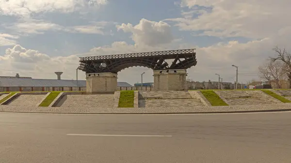 stock image Drobeta Turnu Severin, Romania - March 15, 2024: Model Of Trajans Bridge Over River Danube Historic Landmark From Roman Empire at Roundabout Intersection.