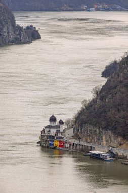 Dubova, Romania - March 14, 2024: Aerial View of Danube River Kazan Gorge Mraconia Monastery at Romanian Coast. clipart