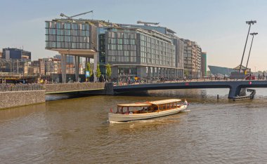 Amsterdam, Netherlands - May 14, 2018: Modern New Double Tree by Hilton Hotel Building at City Central Railway Station. clipart