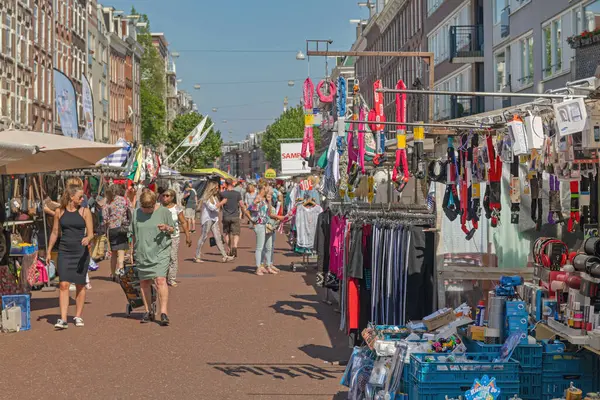 stock image Amsterdam, Netherlands - May 15, 2018: Many People Walking at Flea Market Albert Cuypstraat Street Sunny Spring Day.