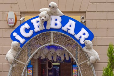 Budapest, Hungary - July 31, 2022: White Polar Bears Plush Toys at Entrance to Ice Bar Cold Coctails Drinks at Regi Posta Street. clipart