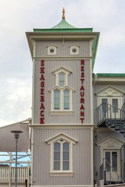 Stromstad, Sweden - November 1, 2016: Sign Skagerack Restaurant at Wooden Building Strandpromenaden Street Autumn Day. clipart