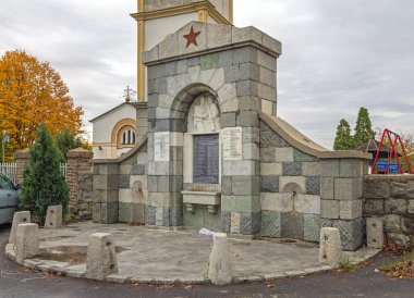 Belgrade, Serbia - October 23, 2021: Memorial Partisan Soldiers From World War Drinking Water Fountain in Front of Church in Beli Potok Autumn Day. clipart