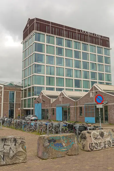 stock image Amsterdam, Netherlands - May 18, 2018: Three Star Hotel Double Tree by Hilton Building at NDSM Wharf Cloudy Spring Day.