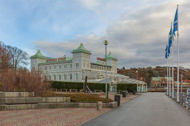 Stromstad, Sweden - November 1, 2016: Skagerack Restaurant Large Wooden Building at Strandpromenaden Street Autumn Day. clipart