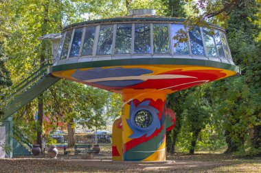 Belgrade, Serbia - October 04, 2021: Art Gallery Atelje Djir Colour Concrete Structure Building Hidden in Woods at Ada Ciganlija Island in Capital City. clipart