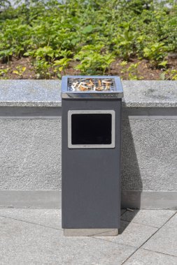 Güneşli bir günde Şehir Parkı 'nda Büyük Ücretsiz Sigara Küllüğü