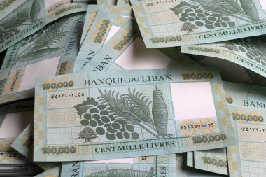 Stacks of Lebanese pounds, 100,000 denomination, symbolizing the downfall of the Lebanese currency.