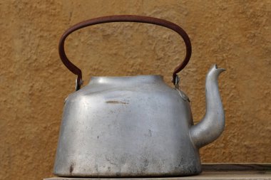 Ahşap bir yüzey üzerinde retro metalik bir kap.