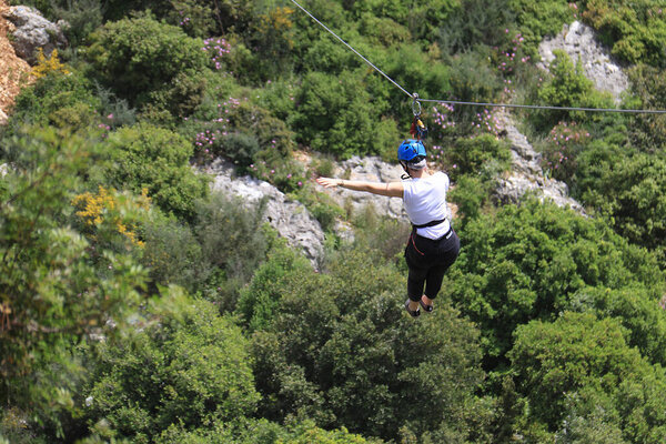A woman ziplining in nature, Lebanon.