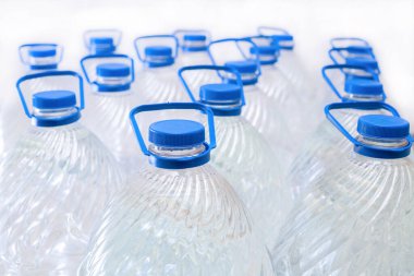 Beyaz arka planda plastik şişelerde su, izole edilmiş.