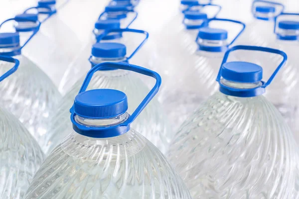 stock image Water in plastic bottles on a white background, isolated