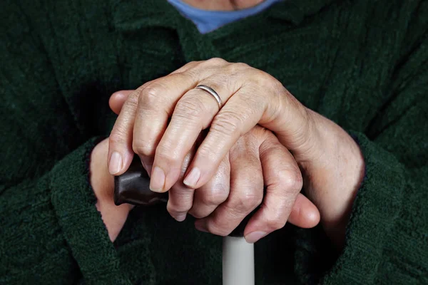 stock image Hands of an elderly woman on a cane, close-up