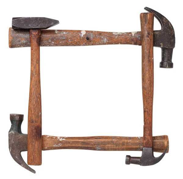 铁锤由四个旧的 磨损的和喷漆的铁锤制成的框架或边框在白雪公主上与外界隔绝 — 图库照片