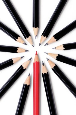 A shiny red pencil stands out in a circle of several shiny black pencils representing an original idea or out of the box thinking. Isolated on white with drop shadows.  clipart
