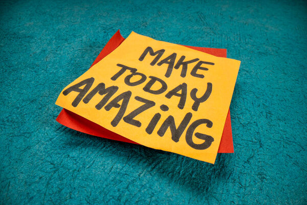 Make today amazing reminder - handwriting on a sticky note against handmade textured paper, low angle macro shot, positivity, optimism and lifestyle concept