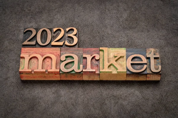 2023 market prediction banner in vintage letterpress wood type against grunge handmade paper, finance, economy and recession concept
