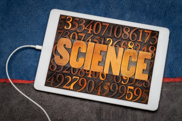 science word in vintage letterpress wood type against number background on a digital tablet