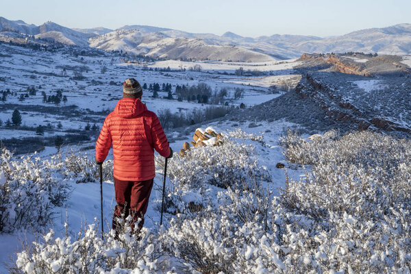 male hiker in winter scenery of Rocky Mountains foothills in northern Colorado, Lory State Park