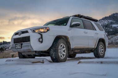 Fort Collins, CO, USA - January 3, 2023:  Toyota 4Runner SUV (2016 Trail edition) at winter dusk parked in a trailhead in Lory State Park at foothills of Rocky Mountains.