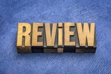 review word abstract in vintage letterpress wood type against textured paper, business analysis, evaluation  and summary concept clipart