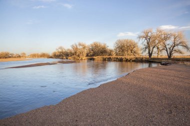 Güney Platte Nehri üzerinde kış günbatımı ve doğu Colorado 'da çakıl barı
