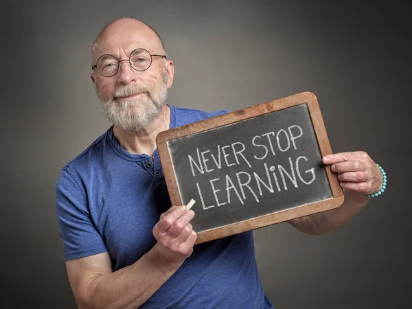 Never Stop Learning Motivation Note Slate Blackboard Held Senior Man — Stock Photo, Image