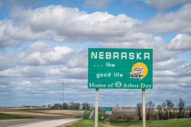 Nebraska, the good life, home of Arbor Day - roadside welcome sign at state border with Kansas, spring scenery clipart