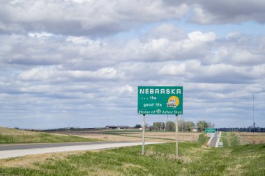 Nebraska, the good life, home of Arbor Day - roadside welcome sign at state border with Kansas, spring scenery clipart
