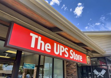 Fort Collins, CO, USA - July 10,2023: Entrance sign for The UPS Store, a subsidiary of United Parcel Service which provides, shipping, shredding, printing, fax, passport photos, personal and business mailboxes. clipart