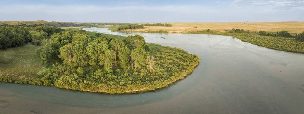 stock image aerial panorama of the Dismal River meandering through Nebraska Sandhills at Nebraska National Forest, late summer scenery at sunset